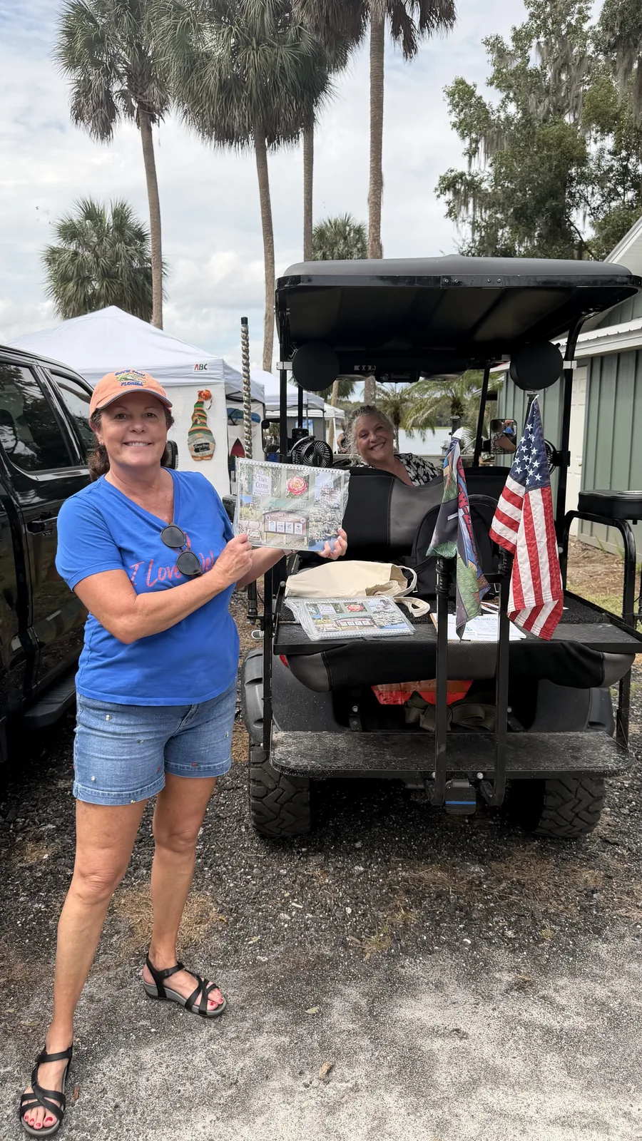A guest beside a golf cart at Cartoberfest on the St. Johns River in Welaka