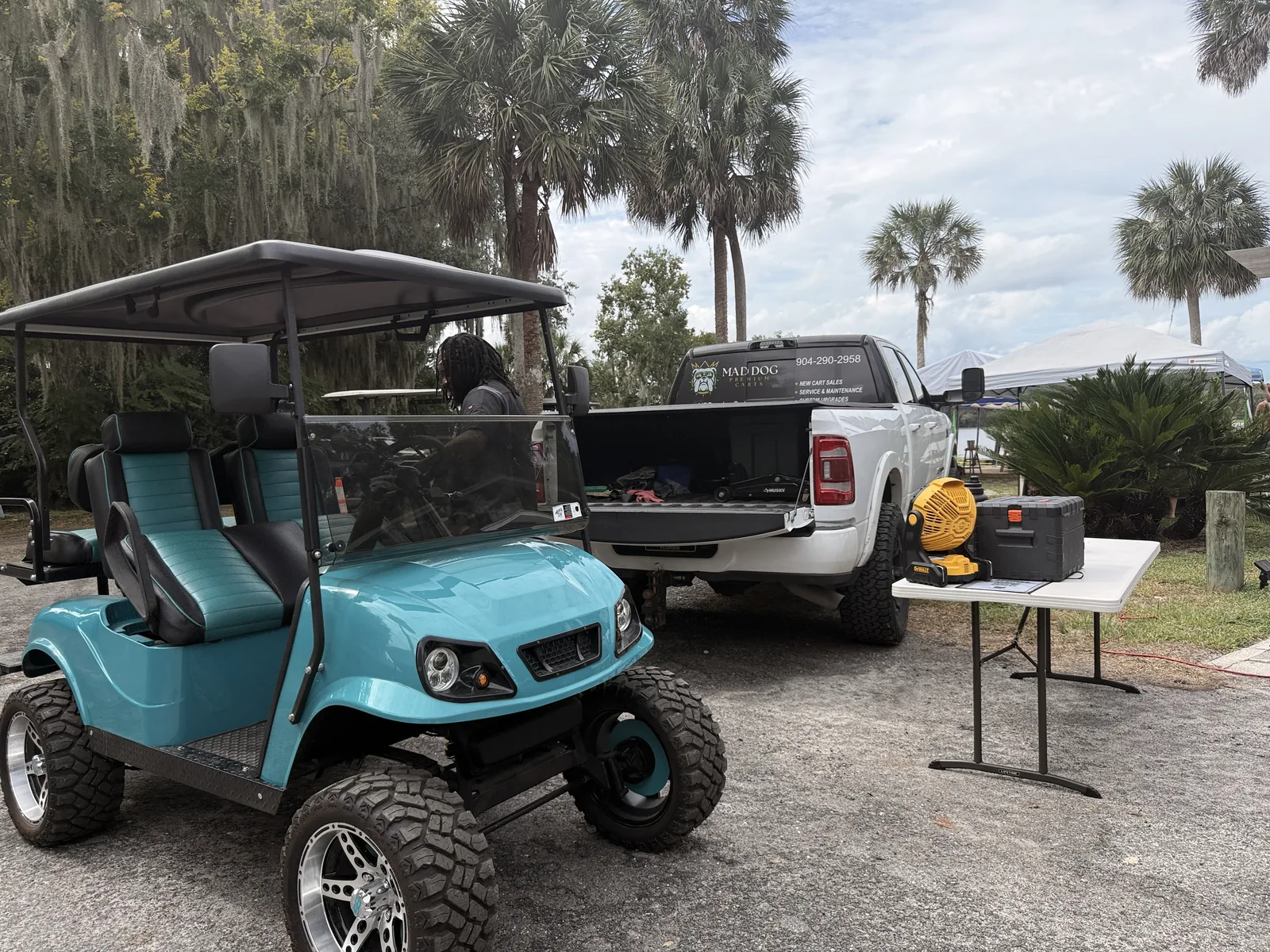 Teal street-legal golf cart parked on the riverfront at Cartoberfest in Welaka, Florida
