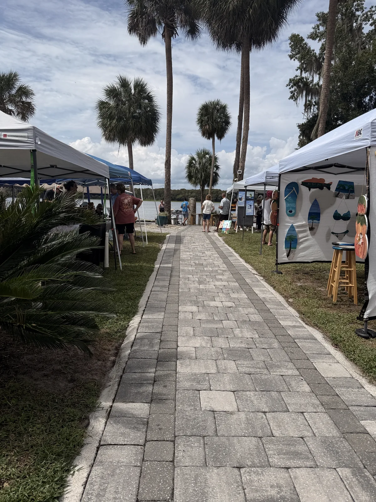 Vendor tents along the paver walkway by the river at Cartoberfest in Welaka