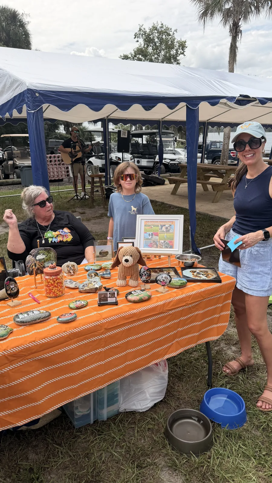 Guests browsing a vendor table at Cartoberfest in Welaka