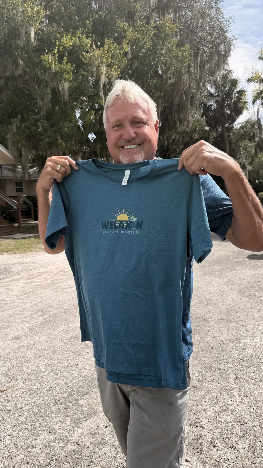A guest holding up a Welaka T-shirt at Cartoberfest
