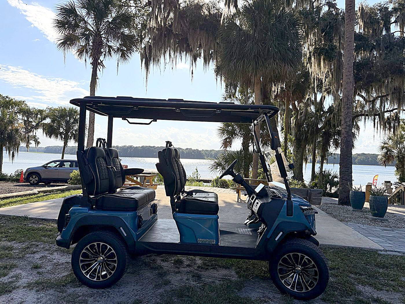 Blue 4-seater golf cart by the St. Johns River