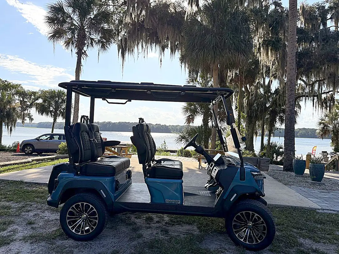 Blue 4-seater golf cart by the St. Johns River