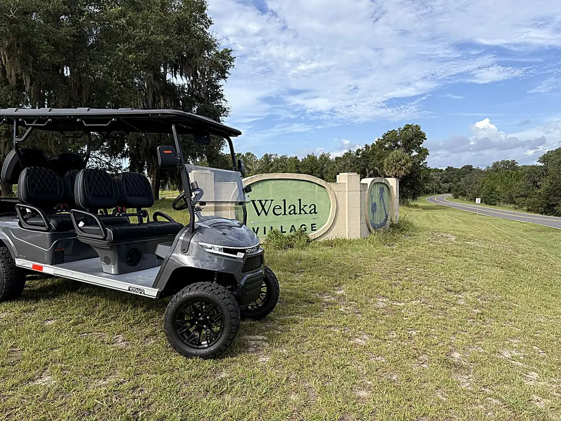 Welaka golf cart by the Welaka Village entrance sign