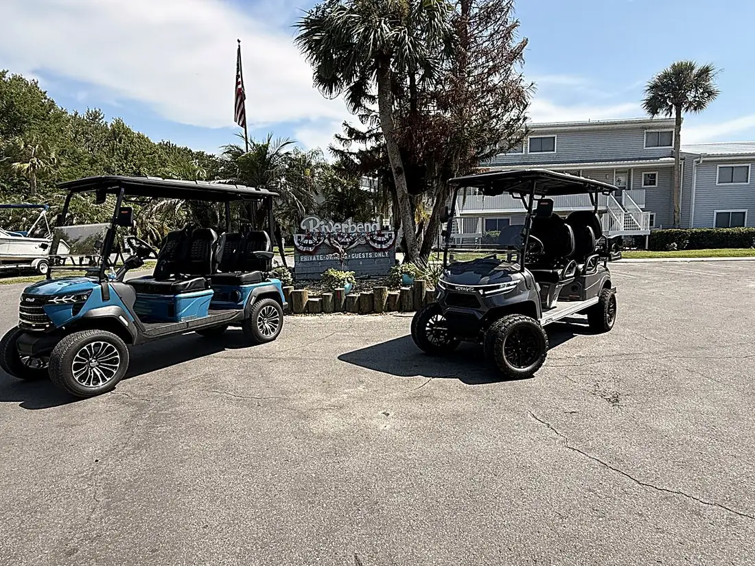Welaka golf carts at a riverfront lodge resort with palm trees
