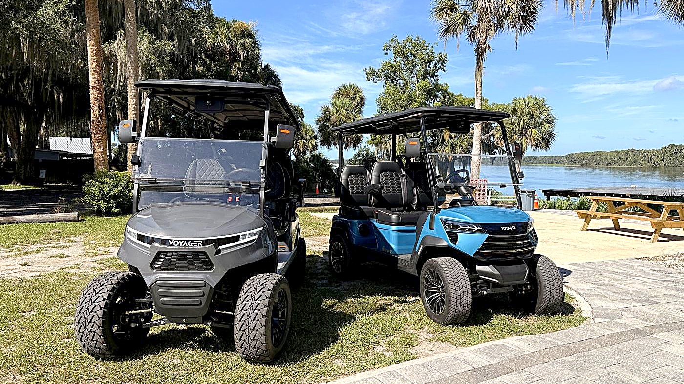 The blue 4-seater and gray 6-seater Welaka golf carts at the St. Johns riverfront