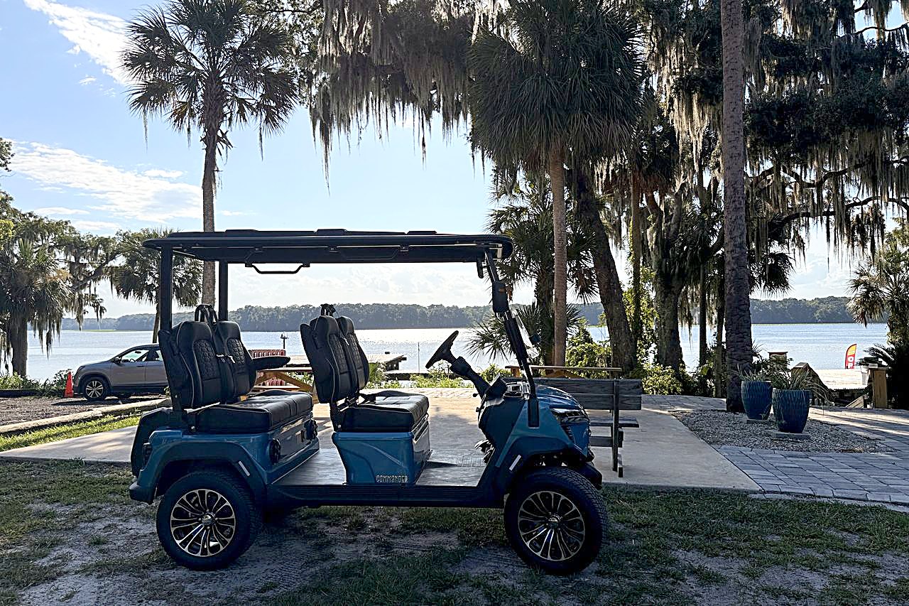 Blue Welaka golf cart by the St. Johns River